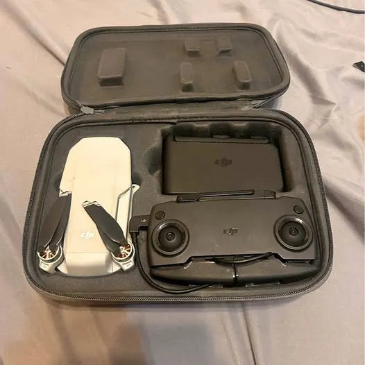 DJI drone and remote in black hard travel case with molded inserts