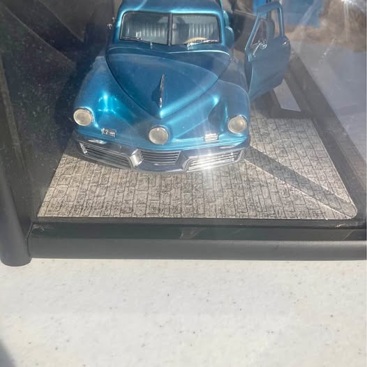 Blue diecast classic truck front view in display case