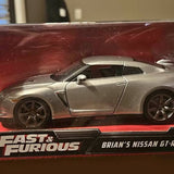 Silver diecast sports car model with black wheels and side profile view