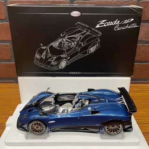 Blue diecast sports car model with open doors and detailed interior.
