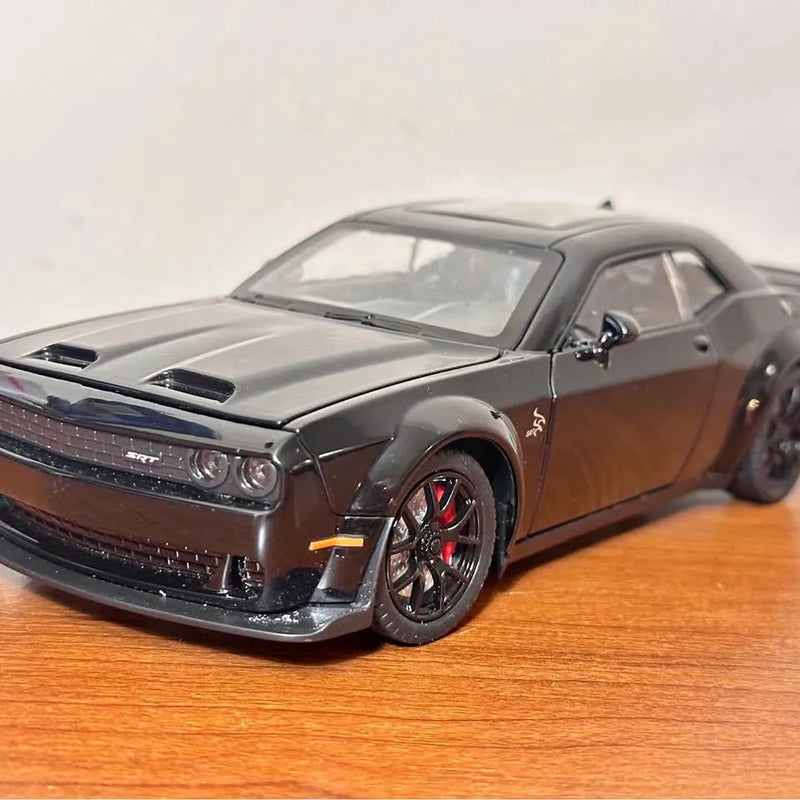 1:24 diecast sports car, gray with black grille and red accents, front 3/4 view