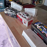 1/24 scale NASCAR diecast red-and-white race car in box, with extra cars