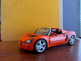 Maisto 1/18 scale diecast orange sports car model, front three-quarter view