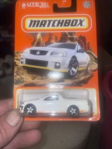 Matchbox diecast UTE model car, white pickup with black wheels, in retail packaging