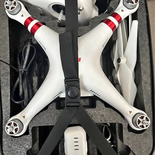 White quadcopter drone with red accents and front camera housing