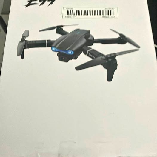 Gray quadcopter drone with four rotors and blue front LEDs