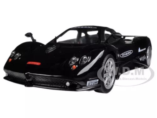 Black die-cast sports car model, front three-quarter view with headlights and grille