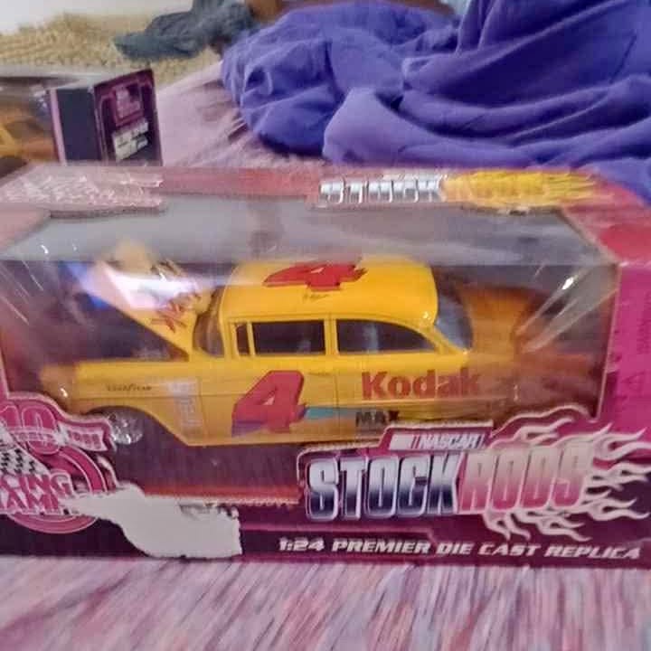 Yellow diecast replica truck with #4 Kodak graphics and flame decals in box