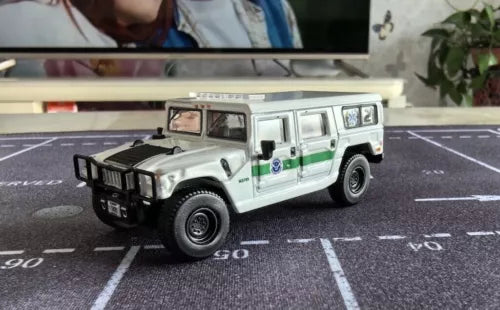 Diecast off-road SUV toy, white with green side stripe and black grille, detailed wheels