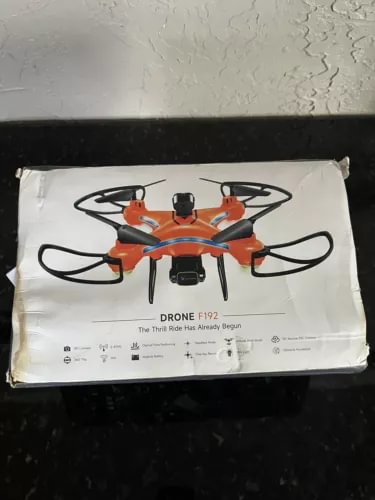 Drone F192 drone in retail packaging with orange and black quadcopter illustration