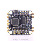 FPV flight controller PCB with ARM chip, mounting holes, and multi-pin connectors