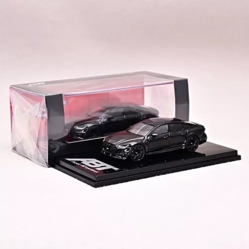 Black diecast sports car model in clear display box on black base