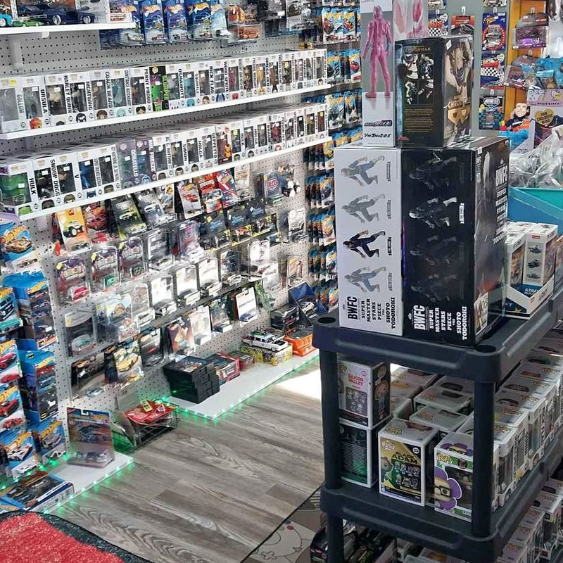 Collectible toy display stand with boxed figures and carded items on shelves