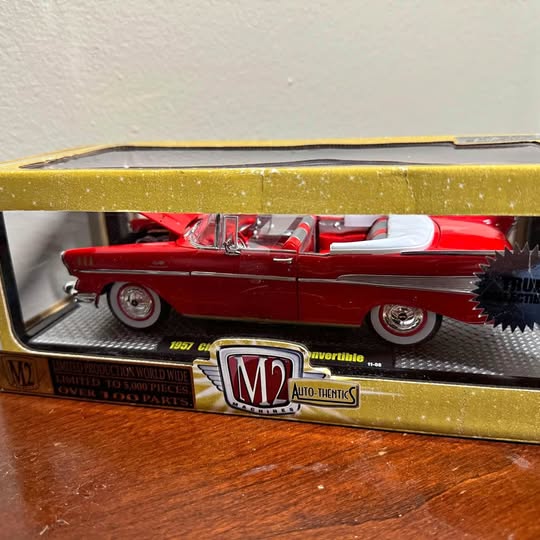Red diecast convertible car in display case