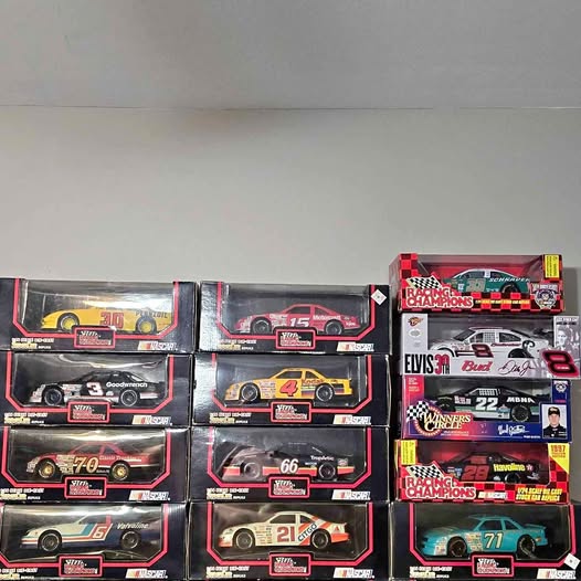 Boxed die-cast 1/24 race cars with assorted numbers and decals, multiple models