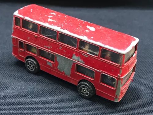 Red diecast bus model with detailed windows and wheels