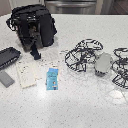 Portable drone kit with folding drone, spare batteries, prop guards, and carrying case