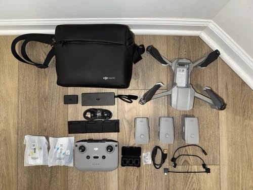 Used drone accessories kit with black carry bag, controller, drone, batteries and cables