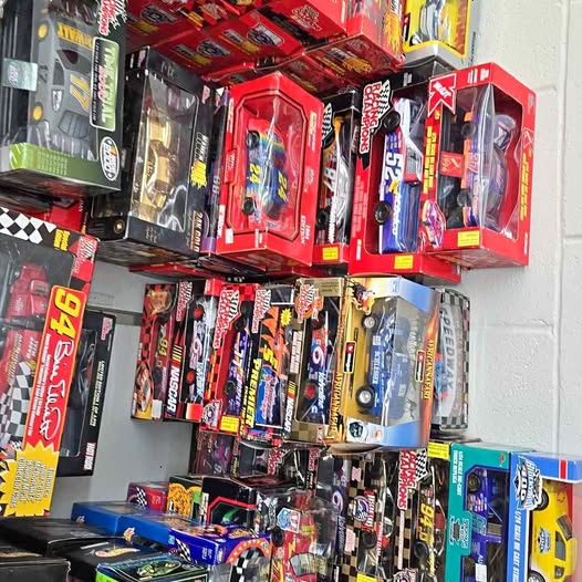 Diecast car models in colorful blister packages on hanging rack