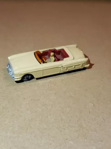 Convertible diecast model car, cream body with open top and red interior