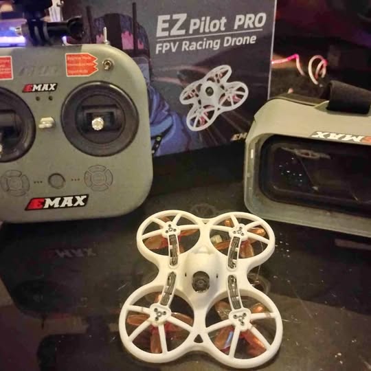 White FPV racing drone with four propellers and circular arm frame