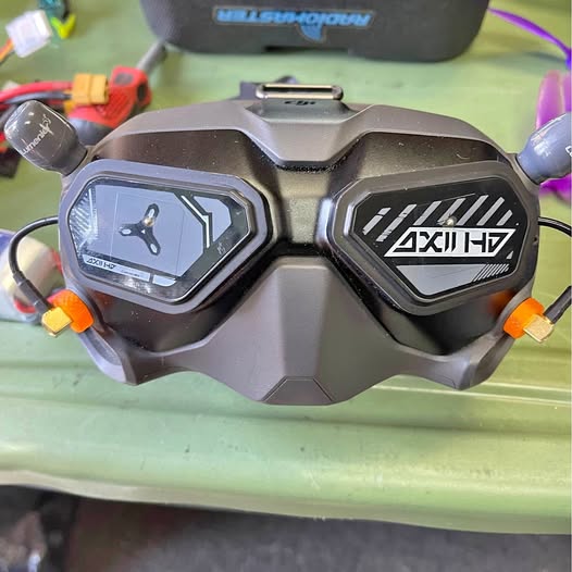 Gray drone body with dual front displays and orange side details