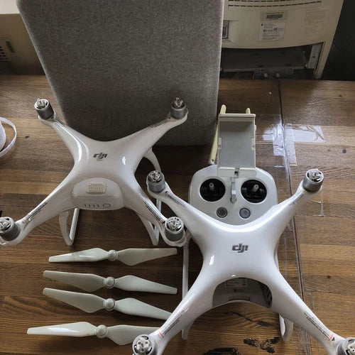 White quadcopter drone pair with propellers and front camera