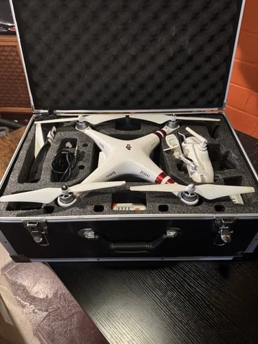 DJI Phantom 1 drone in open hard case, white quadcopter with four propellers