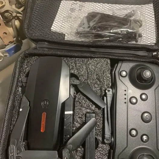 Black folding drone with camera, partially visible inside protective case