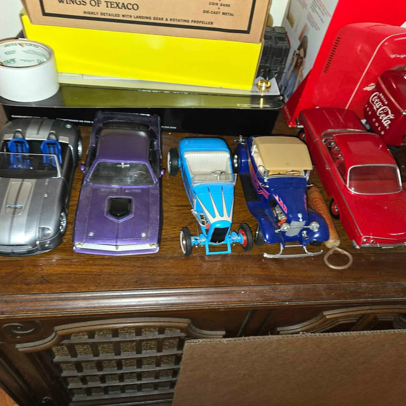 1/18 diecast cars set with purple, blue, silver, and red vehicles on display