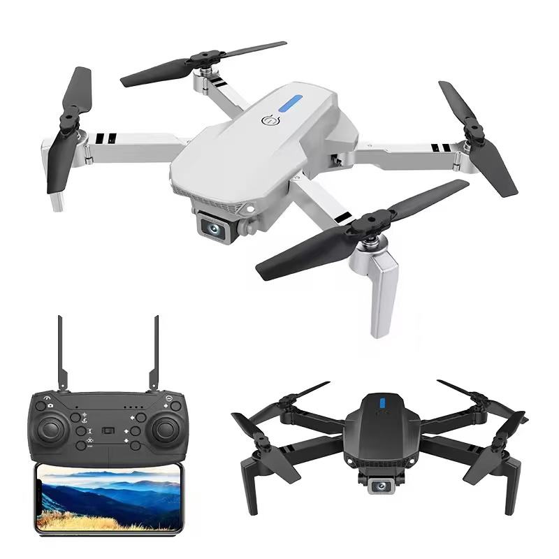 White foldable quadcopter drone with dual camera and black propellers; remote controller shown