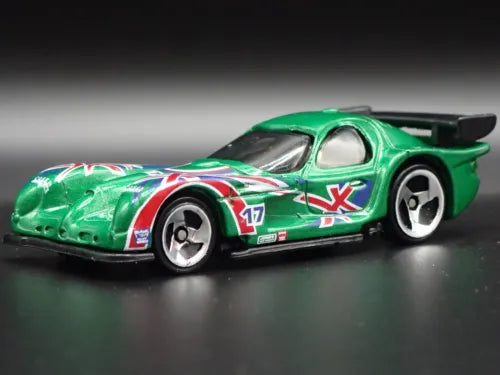 Green race car diecast model with red-white decals, hood scoop, rear wing