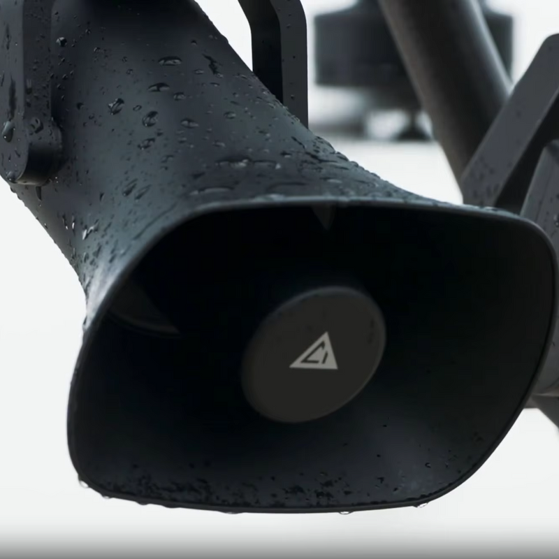 Black horn loudspeaker with circular logo and raindrops