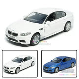 White BMW M5 alloy diecast model car, front three-quarter view, detailed wheels