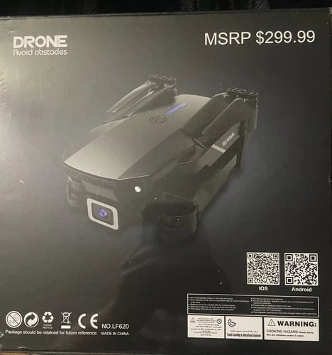 Dark gray quadcopter drone with front camera and obstacle avoidance sensor modules