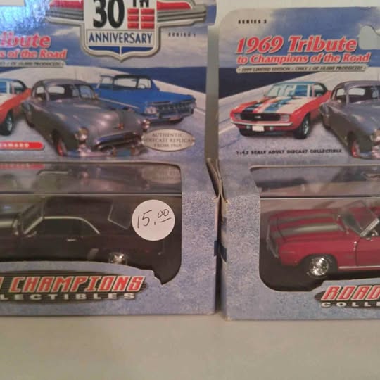 Gray diecast car model in retail box with clear window