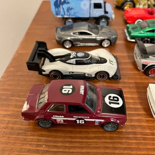Hot Wheels diecast car, maroon with white racing stripes and number 16