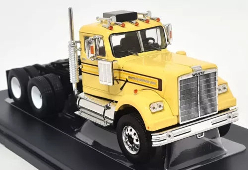 Yellow diecast scale model truck with chrome grille and black chassis on base
