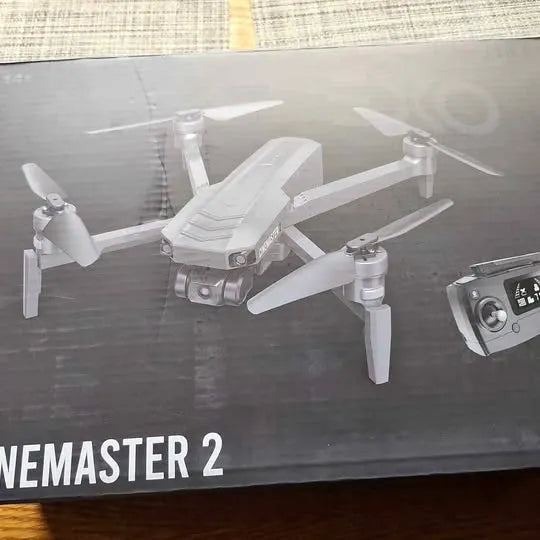 White quadcopter drone with four rotors and central camera module