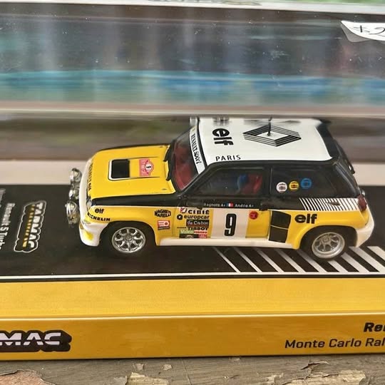 Yellow and black diecast race car model with white roof and #9 on door