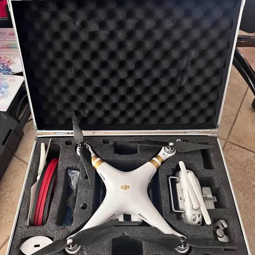 DJI Phantom drone in foam case, white body with black propellers and remote controller