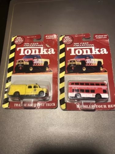 Diecast tour bus and truck in red retail boxes, with yellow taxi and red bus