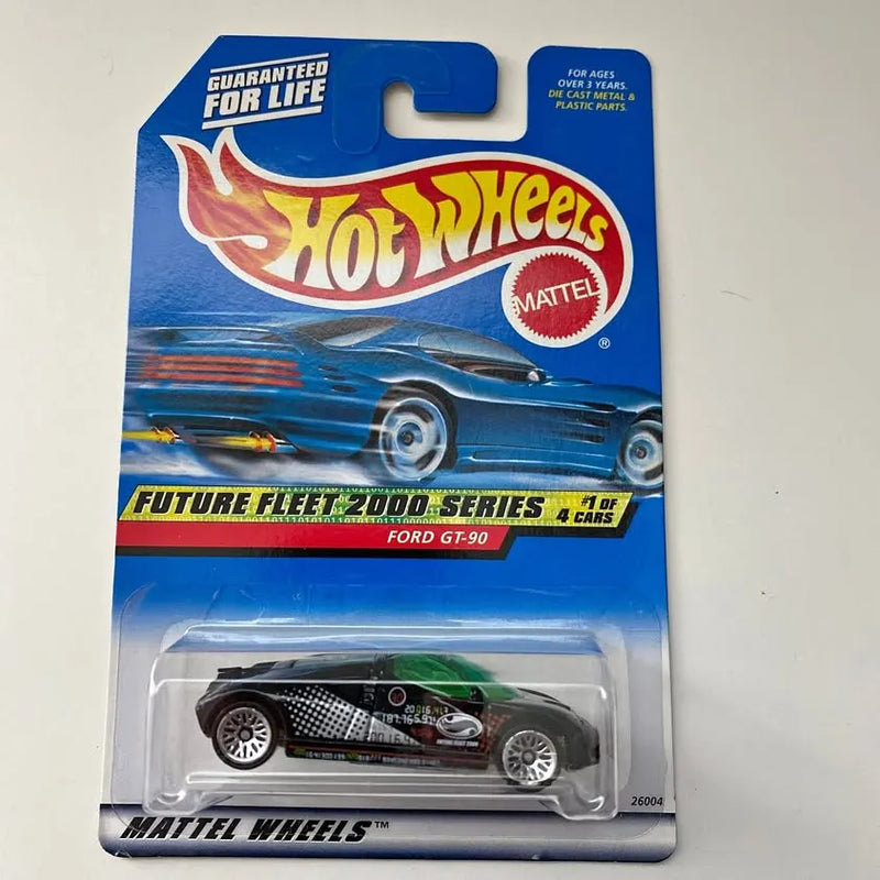 Hot Wheels diecast car in blister, black and green racing Ford GT-90.