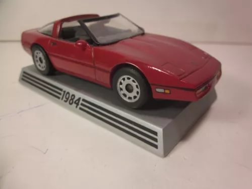 Red 1984-style Corvette coupe diecast model on display base