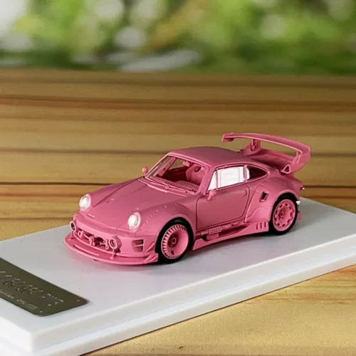 Pink 1/64 diecast model car with rear spoiler and open hood