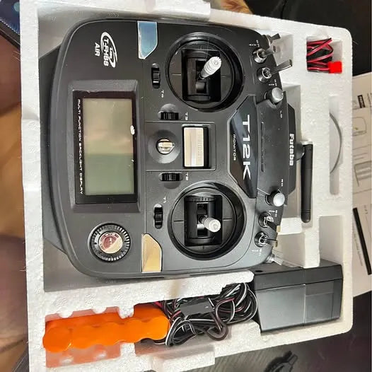 Futaba 12k racing drone transmitter with LCD screen, dual control sticks, and switch panel