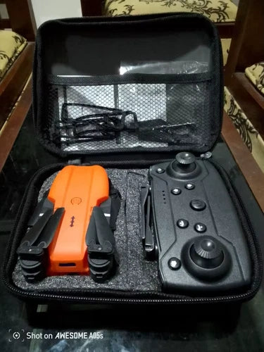 Orange drone and controller in hard travel case