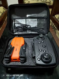 Orange drone and controller in hard travel case