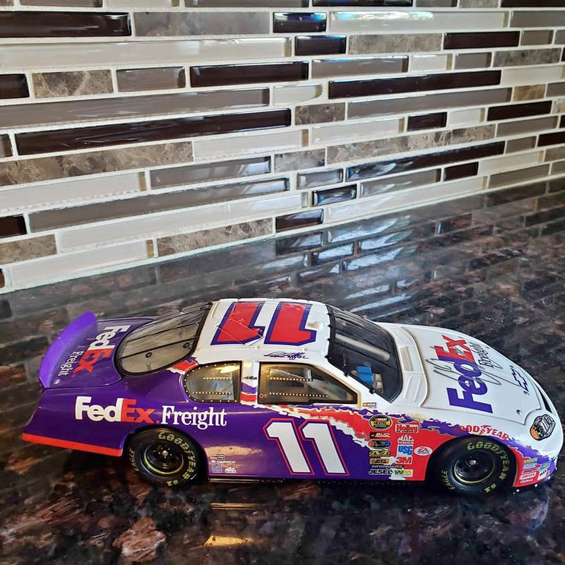 NASCAR 1:24 diecast race car with purple and white FedEx Freight livery, #11