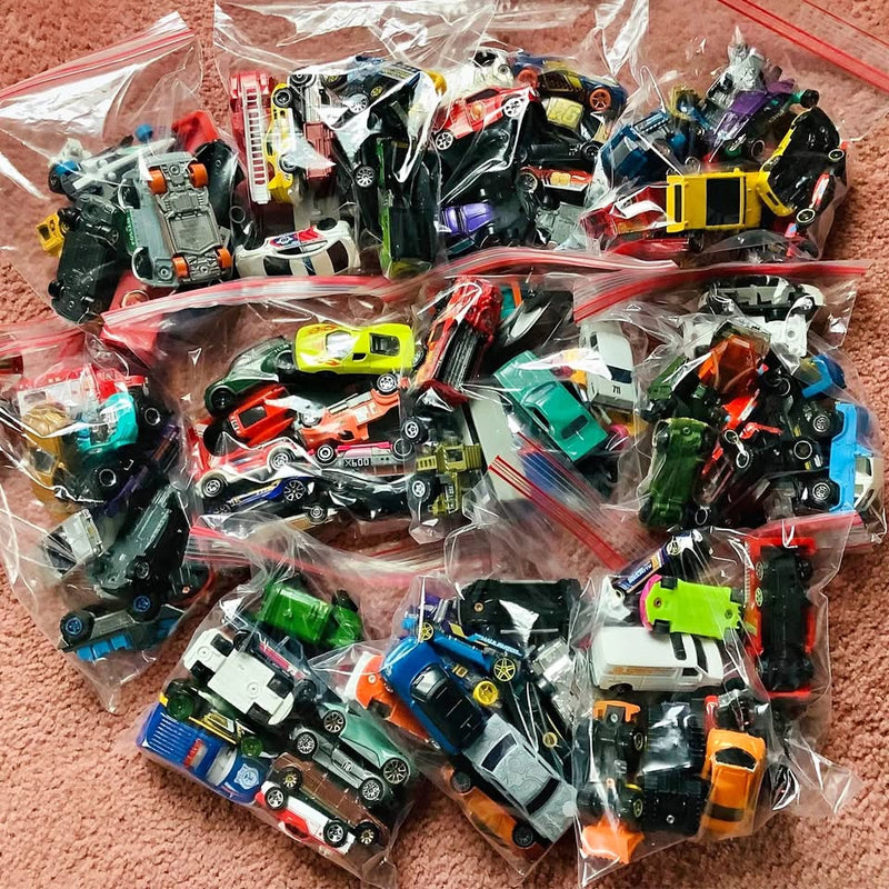 Bag of assorted diecast toy vehicles, mixed cars and trucks in clear packaging